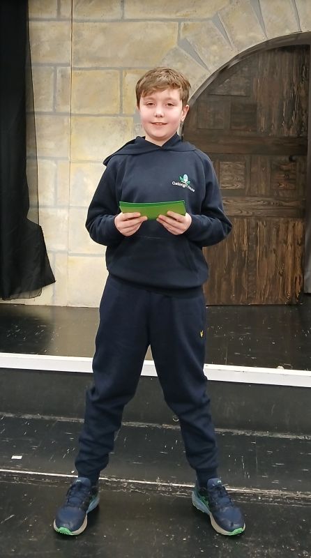 A young boy reading a poem